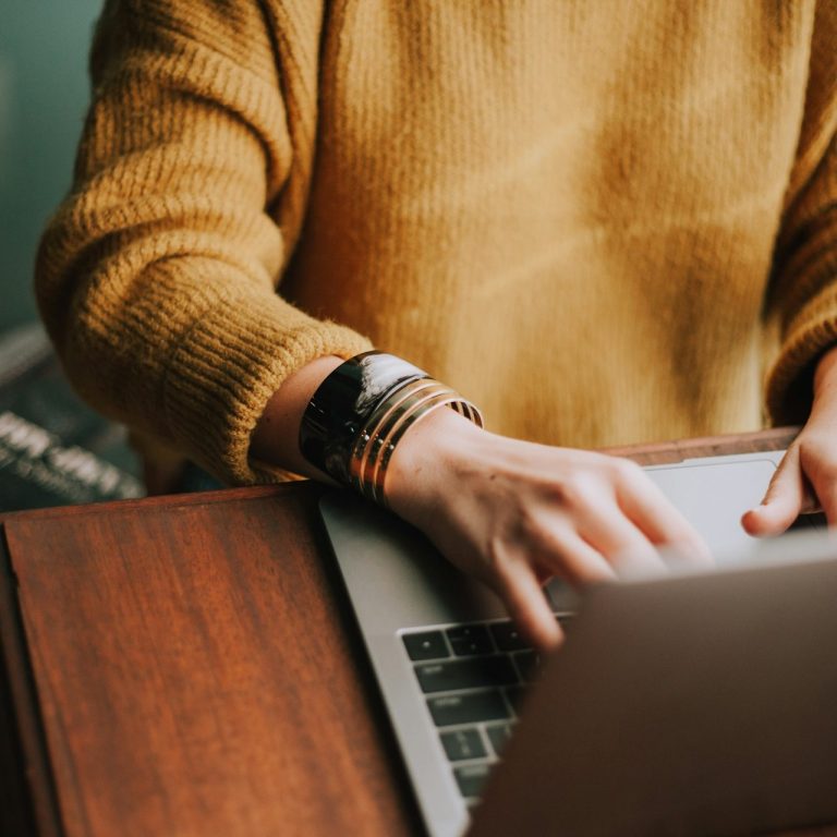 Person completing a cybersecurity risk assessment on a laptop