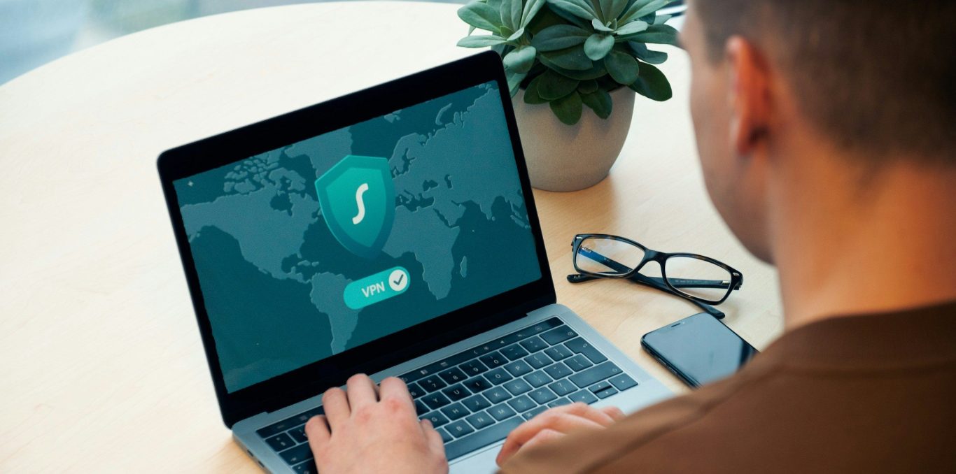 Laptop showing a world map and VPN security icon