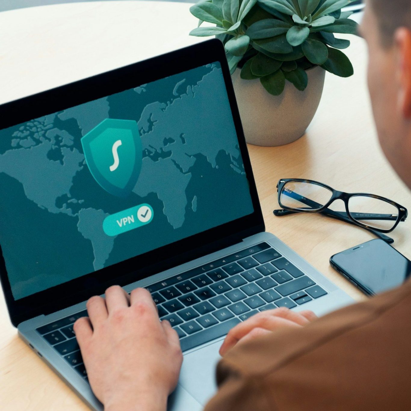 Laptop displaying a world map with a VPN security icon